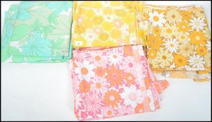 A collection of retro 20th century linens in a variety of colours and patterns, please refer to