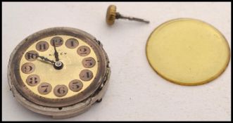 An early 20th century Rolex wristwatch movement and dial. The glass and winder loose, no case or