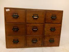 A vintage industrial early 20th century 1930's bank of nine industrial oak index  filing cabinet.
