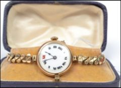 A vintage 20th century 9ct gold cocktail watch having an enamel face with roman numeral chapter ring