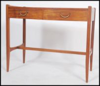 A mid century teak and mahogany writing table desk having chamfered edge squared legs united by