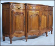 A Provincial French walnut large bow front sideboard dresser having a parquetry top with four frieze