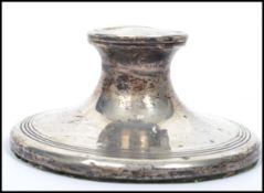 A silver hallmarked desk top capstan inkwell having hinged top. London marked passant lion with date