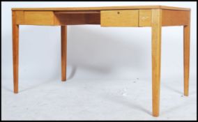 A  mid century Air Ministry writing table desk of large form in golden oak having tuck away legs