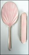 A mid 20th century silver hallmarked mirror and brush set having pink enameling, being hallmarked