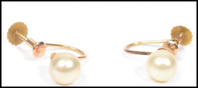 A pair of 9ct gold twist back earrings with large pearl to each. Stamped 9ct total weight 1.4