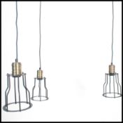 A group of three vintage industrial style pedant ceiling cage lights, black wire work cages with