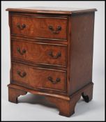 A vintage 20th century 1930s Burr Walnut serpentine bedside chest of three drawers. Raised on