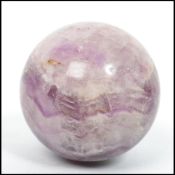 An unusual believed 20th century Blue John style ball / globe purple glass paperweight of