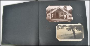 A vintage 20th century postcard album containing various topographical, real photo cards, 1920s