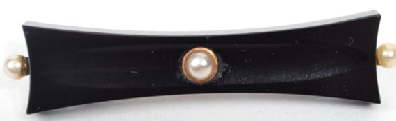 A 19th century Victorian French jet mourning brooch set with pearls having a 15ct gold back with pin