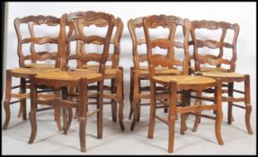 A good harlequin set / long run of 10 French country oak and rattan upholstered dining chairs.
