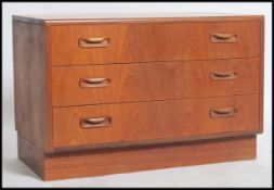 A retro 1960s G-plan low teak chest of drawers having a bank of three drawers. measures 54 x 81 x