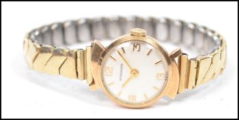 A vintage 20th century 14ct gold Huguenin ladies cocktail watch having an enamel face with gilt