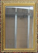 A large contemporary gilt framed mirror, moulded gilt frame with central bevel edge mirror panel.