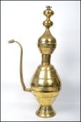 A 20th century Islamic / Indian brass large floor standing coffee pot of banded form having a shaped