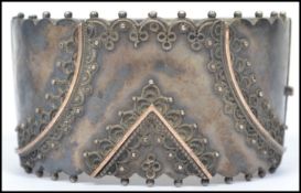 A silver 19th century ladies large bangle having clip clasp and adorned with filigree work