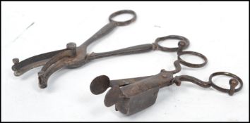 A pair of 19th century metamorphic candle snuff scissors along with a pair of ornate grape scissors.