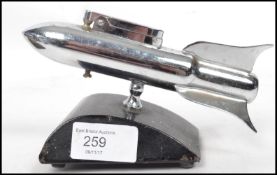A vintage 20th century retro 1960's chrome plated novelty space rocket table lighter raised on