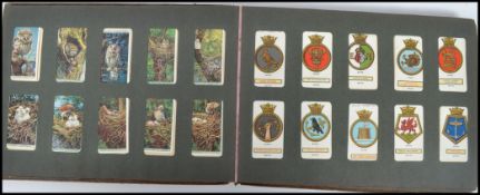 A vintage 20th century cigarette card album containing various sets to include flowers, shipping