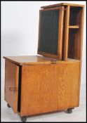 A mid century unusual library table / study stand with pedestal base and single locker cupboard with