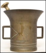 A 19th century bronze  and brass pestle and mortar. The bronze mortal of cylindrical form having