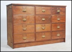 A vintage 20th century merchants shop haberdashery large chest of drawers cabinet having 12 drawers,