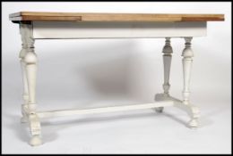 A vintage 20th century oak topped up - cycled painted draw leaf dining table, raised on a painted