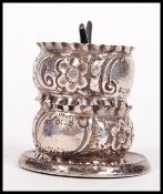 A silver hallmarked ring holder having 4 branch tree to centre on terraced base being hallmarked for