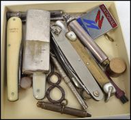 A group of vintage 20th century curious to include various pen knives, lighter, pin badge, silver