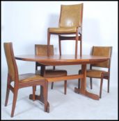 A 1970's G Plan teak extending dining table. Raised on tapered legs with a fitted frieze. Above an
