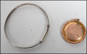 A 9ct gold front and back early 20th century ladies locket with swallows and foliate decoration