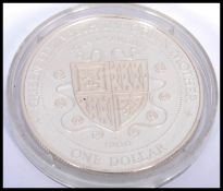 A silver proof Cayman Islands commemorative One Dollar coin, to commemorate the birth of jtjhe Queen