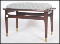 A retro 1970's mahogany dressing table stool of rectangular form raised on tapering round legs being