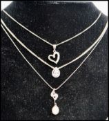 Three 925 silver pendant necklaces having white stone and pearl set pendants. Marked 925