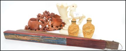 A group of items to include an alabaster spill vase in the form of a cockatoo, a soap stone Oriental