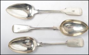 A set of 3 mid 19th century solid silver large serving spoons bearing monograms to the handles.