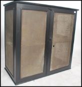 A large vintage early 20th century meat safe locker of ebonised pine construction with mesh lined