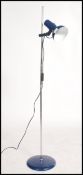 A retro 20th century floor standing floor lamp / light, raised on a blue circular base with an