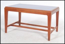 A vintage / retro 20th century Danish inspired teak wood coffee table, raised on shaped supports