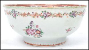 An 18th / 19th century Chinese famille rose bowl of circular form being handpainted with floral