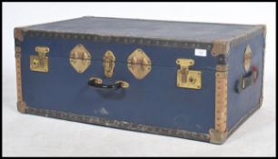 A vintage 20th century steamer trunk, hinged lid studded detail finish and in the original blue.