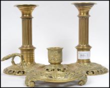 A pair of 19th century cast brass candlesticks having a pierced base with classical column with