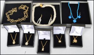 A group of contemporary necklaces to include a gilt curb link chain with elephant pendant, owl