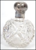 A 19th century silver topped cut glass perfumer bottle, the silver hallmarked lid with cherubs to