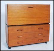 A retro teak wood ladderax style cabinet raised on castors together with another modular part,
