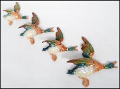A good set of four 20th century Beswick wall plaques in the form of flying mallards  ( ducks )