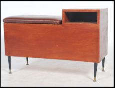 A vintage 20th century retro telephone table seat raised on ebonised tapering legs. Measures 44cms x