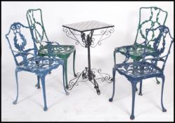 A set of 4 cast metal garden chairs to include also a marble inset garden table with chess set