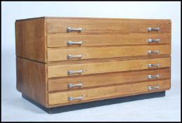 A vintage mid century oak twin section Industrial architects plan chest of drawers. Raised on an